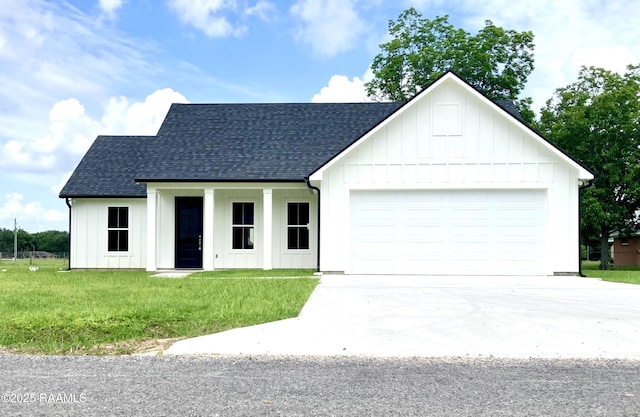 127 Guard Rd, Scott, LA 70583 - modern inspired farmhouse featuring a shingled roof, board and batten siding, concrete driveway, and a front lawn