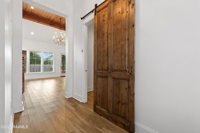 303 Canary Palm Way, Youngsville, LA 70592 - hallway featuring beamed ceiling, wood finished floors, a barn door, recessed lighting, and a chandelier