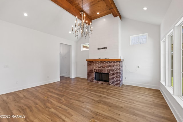 303 Canary Palm Way, Youngsville, LA 70592 - unfurnished living room featuring beam ceiling, wood finished floors, a chandelier, high vaulted ceiling, and a brick fireplace