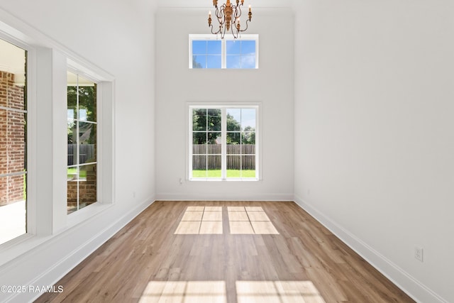 303 Canary Palm Way, Youngsville, LA 70592 - empty room featuring a chandelier and wood finished floors