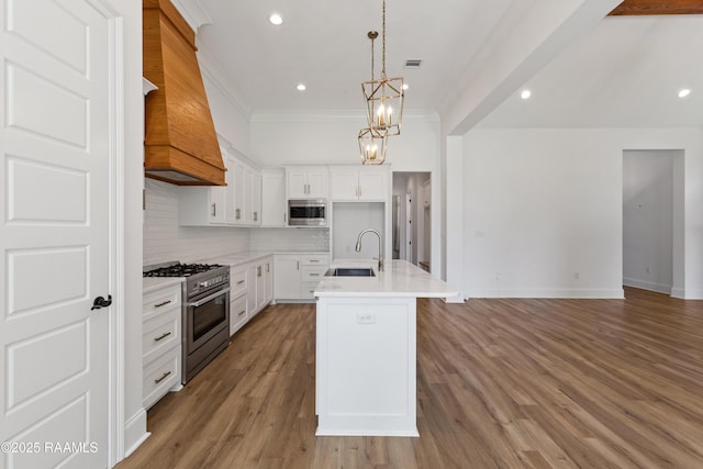 303 Canary Palm Way, Youngsville, LA 70592 - kitchen featuring appliances with stainless steel finishes, decorative backsplash, light countertops, a chandelier, and light wood-style flooring