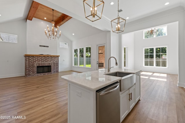 303 Canary Palm Way, Youngsville, LA 70592 - kitchen featuring dishwasher, open floor plan, a chandelier, high vaulted ceiling, and beamed ceiling