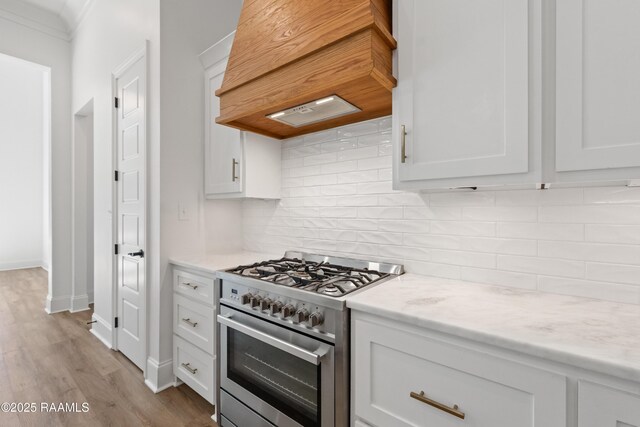 303 Canary Palm Way, Youngsville, LA 70592 - kitchen with high end range, custom range hood, white cabinetry, wood finished floors, and light stone counters