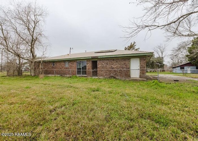 1010 Dugas Ln, Saint Martinville, LA 70582 - rear view of house featuring brick siding and solar panels