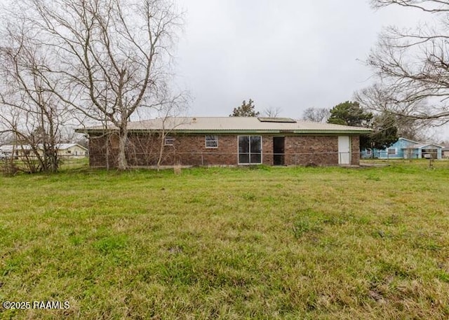 1010 Dugas Ln, Saint Martinville, LA 70582 - rear view of house with a yard and brick siding