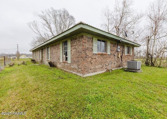 1010 Dugas Ln, Saint Martinville, LA 70582 - view of home's exterior featuring brick siding and central AC unit