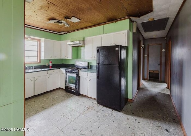 1010 Dugas Ln, Saint Martinville, LA 70582 - kitchen with freestanding refrigerator, range with gas stovetop, wood ceiling, white cabinets, and under cabinet range hood