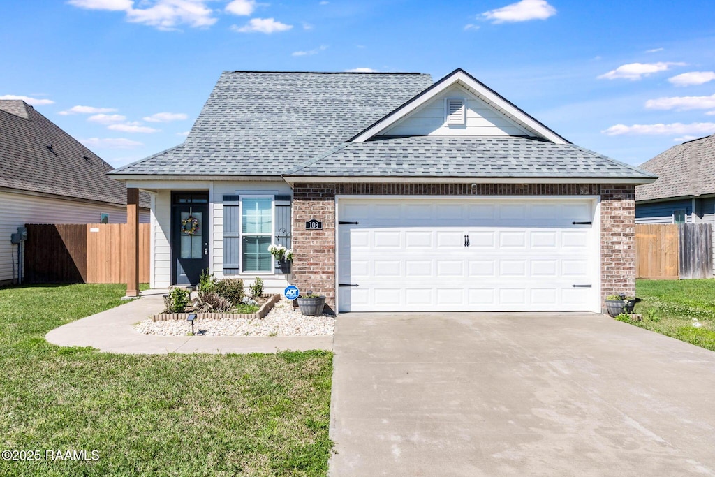 103 Harvest Ct, Abbeville, LA 70510 - view of front of house featuring fence, roof with shingles, concrete driveway, a garage, and brick siding