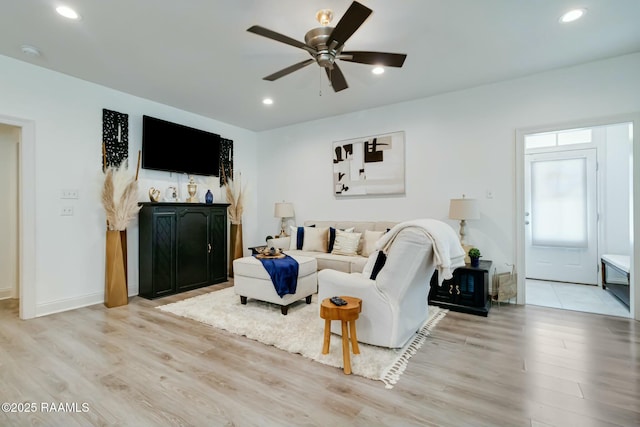 living room featuring recessed lighting, baseboards, light wood-style flooring, and a ceiling fan