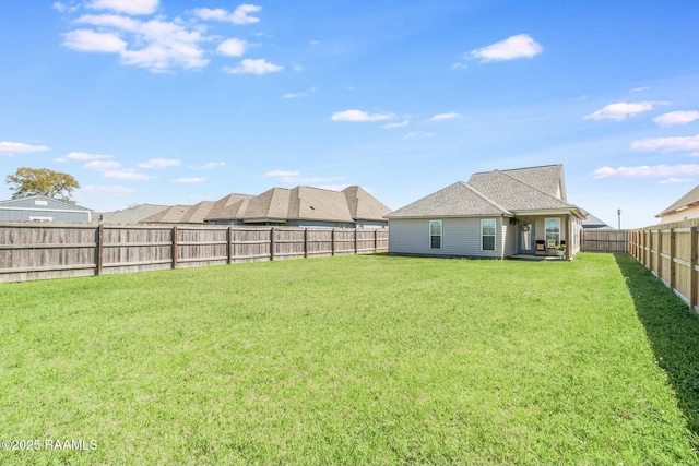 view of yard with a fenced backyard