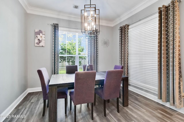 205 Lo Saab Cv, Lafayette, LA 70506 - dining area featuring a chandelier, wood finished floors, crown molding, and baseboards