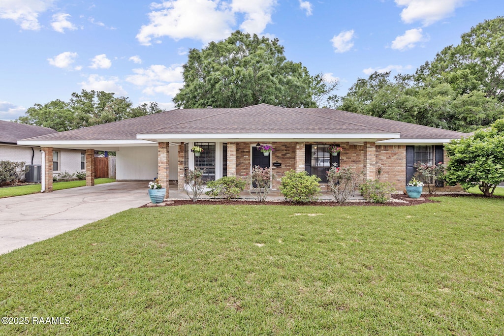 ranch-style home featuring central air condition unit, an attached carport, a porch, a front yard, and brick siding