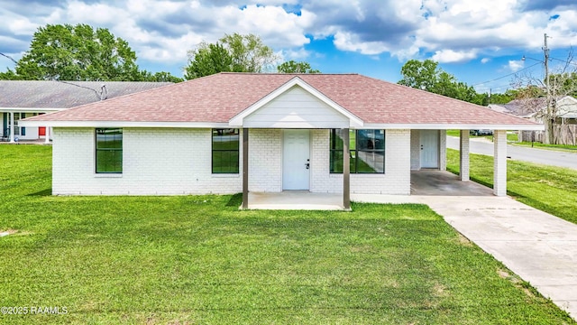 2000 Martin Luther King Dr, Jeanerette, LA 70544 - ranch-style house featuring brick siding, a shingled roof, concrete driveway, a front yard, and a carport