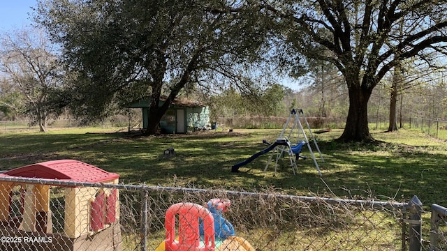 178 Wild Iris Dr, Evangeline, LA 70537 - view of yard with fence, an outdoor structure, a shed, and a playground