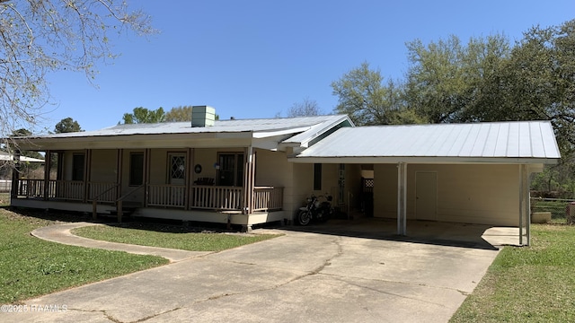 178 Wild Iris Dr, Evangeline, LA 70537 - view of front of home featuring an attached carport, a porch, metal roof, and driveway
