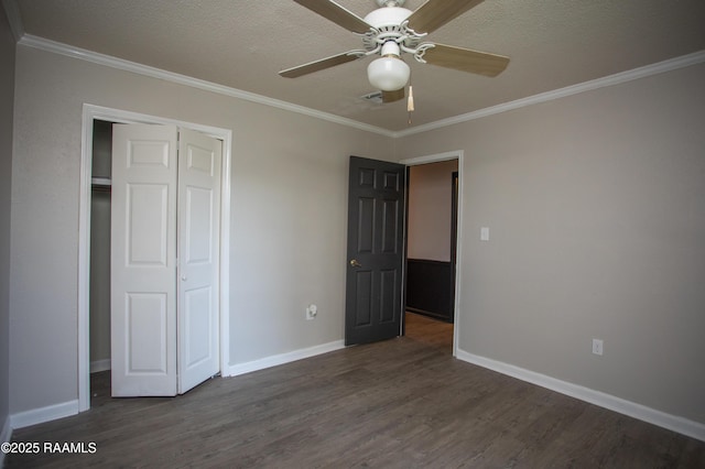 104 Raphael Dr, Lafayette, LA 70508 - unfurnished bedroom featuring dark wood finished floors, ornamental molding, a closet, and a ceiling fan