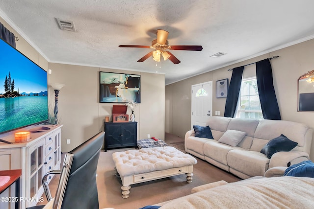 carpeted living room with visible vents, a ceiling fan, and crown molding