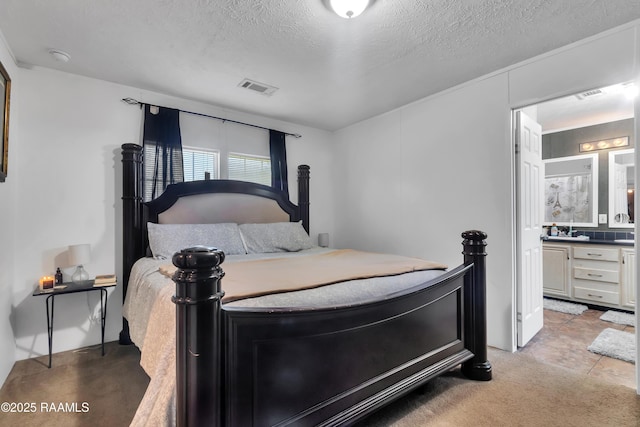 bedroom featuring a textured ceiling, visible vents, light carpet, and ensuite bathroom