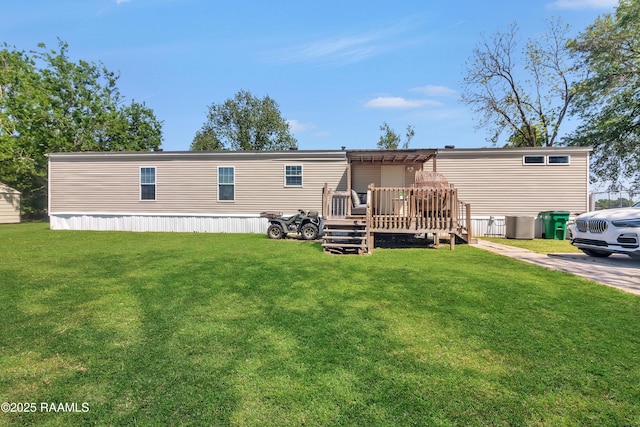 back of property featuring a lawn, a wooden deck, and central AC