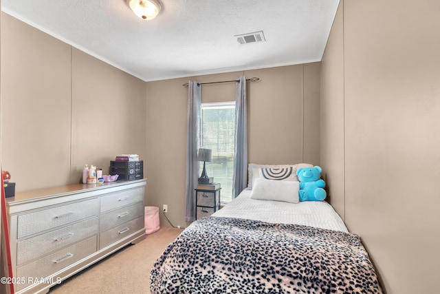 bedroom featuring visible vents, light carpet, and crown molding