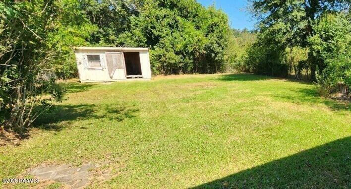 605 Choctaw Dr, Opelousas, LA 70570 - view of yard with an outdoor structure and a shed