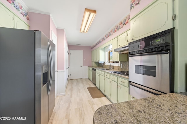 300 W Saint Louis St, Lafayette, LA 70506 - kitchen featuring crown molding, appliances with stainless steel finishes, a sink, and green cabinetry