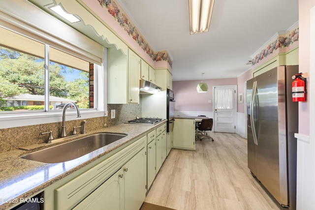 300 W Saint Louis St, Lafayette, LA 70506 - kitchen with hanging light fixtures, a sink, under cabinet range hood, stainless steel appliances, and light stone counters