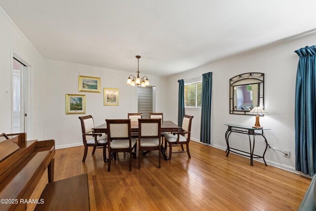 300 W Saint Louis St, Lafayette, LA 70506 - dining room with ornamental molding, baseboards, a chandelier, and light wood-style floors