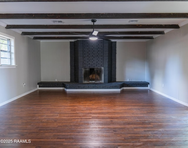 unfurnished living room with beam ceiling, visible vents, wood finished floors, and a fireplace