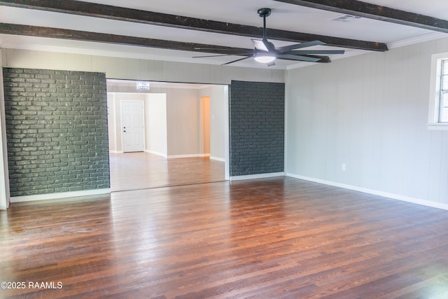 spare room with ceiling fan, visible vents, wood finished floors, baseboards, and beamed ceiling