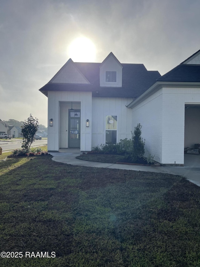view of front of house featuring board and batten siding and a front lawn