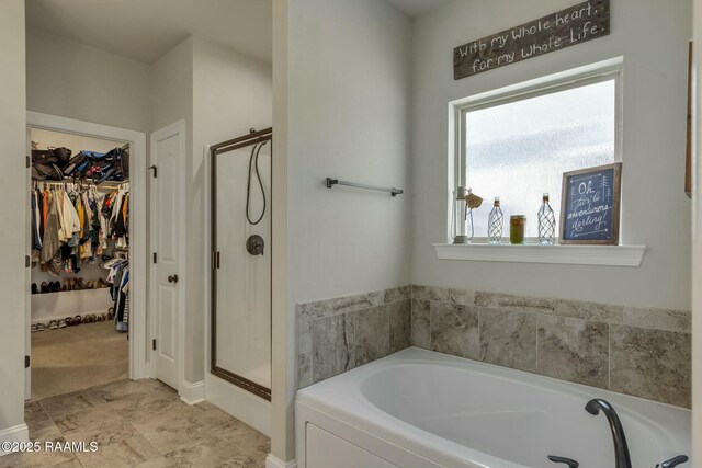 114 Marigold Ln, Maurice, LA 70555 - bathroom featuring a spacious closet, a stall shower, and a bath
