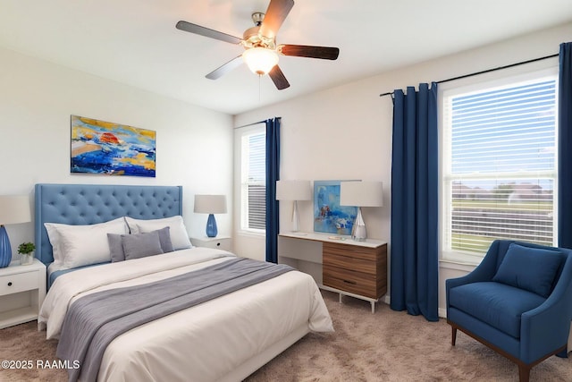 bedroom with a ceiling fan and light colored carpet