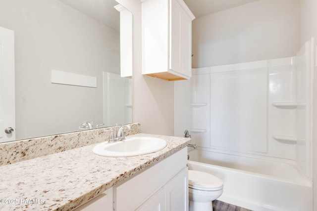 bathroom with toilet, vanity, and washtub / shower combination