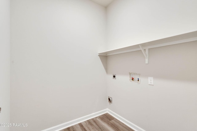 clothes washing area with hookup for an electric dryer, baseboards, hookup for a washing machine, wood finished floors, and laundry area