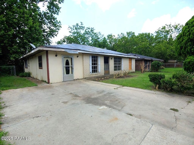 802 Myrtis St, New Iberia, LA 70560 - ranch-style home with a front lawn, a patio area, driveway, and brick siding