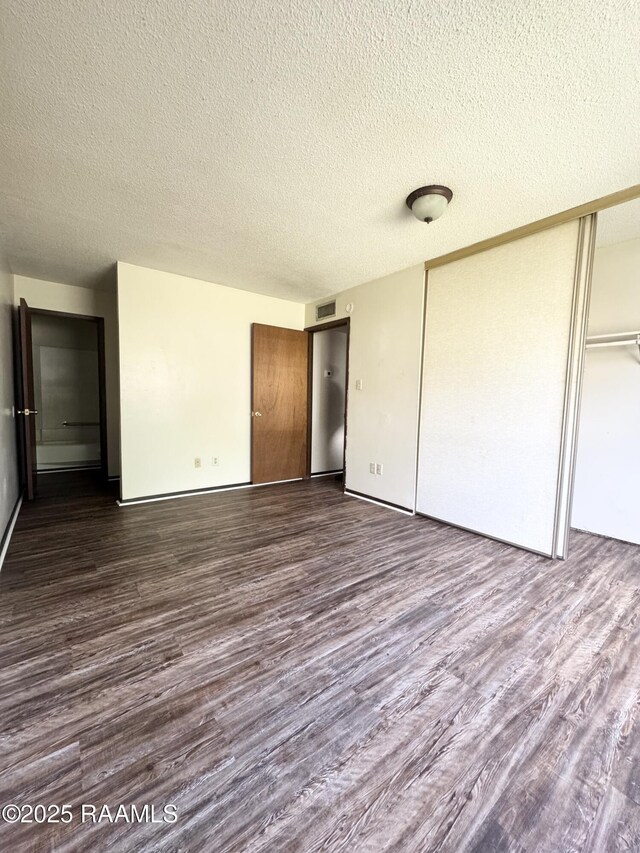 200 High Meadow Blvd Unit A-3A, Lafayette, LA 70507 - unfurnished bedroom with a closet, dark wood-style flooring, a textured ceiling, and visible vents