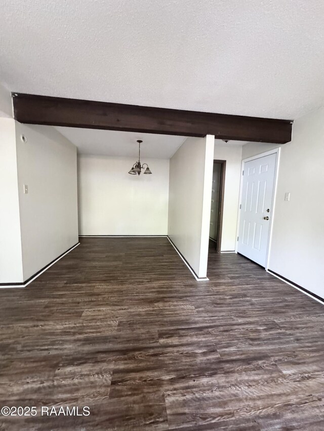 200 High Meadow Blvd Unit A-3A, Lafayette, LA 70507 - unfurnished room featuring dark wood finished floors, beamed ceiling, and a textured ceiling