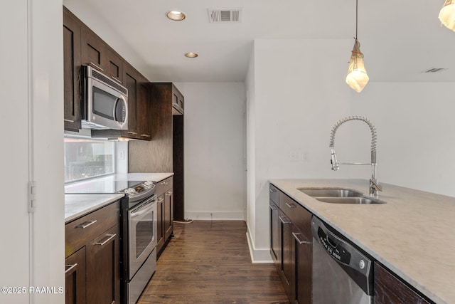 1201 S College Rd Unit 10, Lafayette, LA 70503 - kitchen with dark brown cabinetry, a sink, stainless steel appliances, recessed lighting, and visible vents