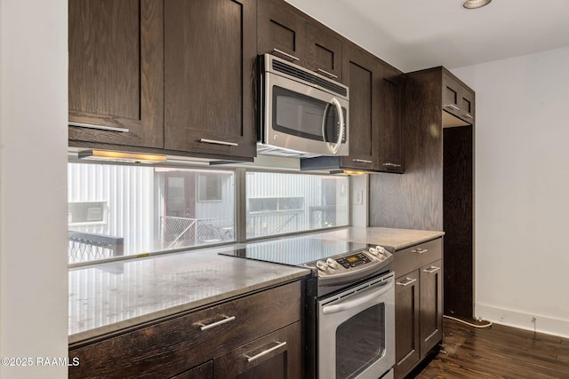 1201 S College Rd Unit 10, Lafayette, LA 70503 - kitchen with appliances with stainless steel finishes, light stone countertops, dark brown cabinets, baseboards, and dark wood-style floors