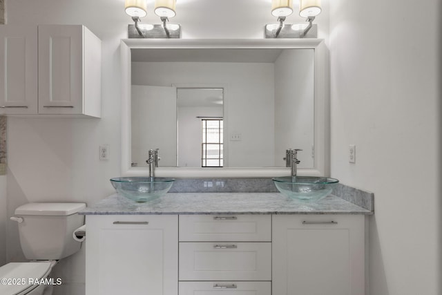 1201 S College Rd Unit 10, Lafayette, LA 70503 - bathroom with double vanity, toilet, and a sink