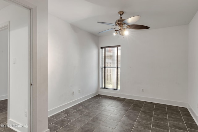 1201 S College Rd Unit 10, Lafayette, LA 70503 - unfurnished room featuring baseboards, dark tile patterned floors, and ceiling fan