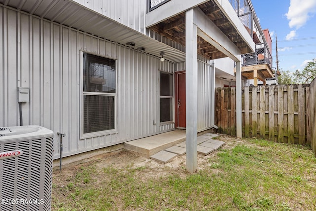 1201 S College Rd Unit 10, Lafayette, LA 70503 - view of home's exterior with fence, board and batten siding, and central AC