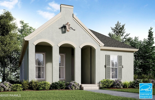 view of front of home featuring stucco siding and roof with shingles