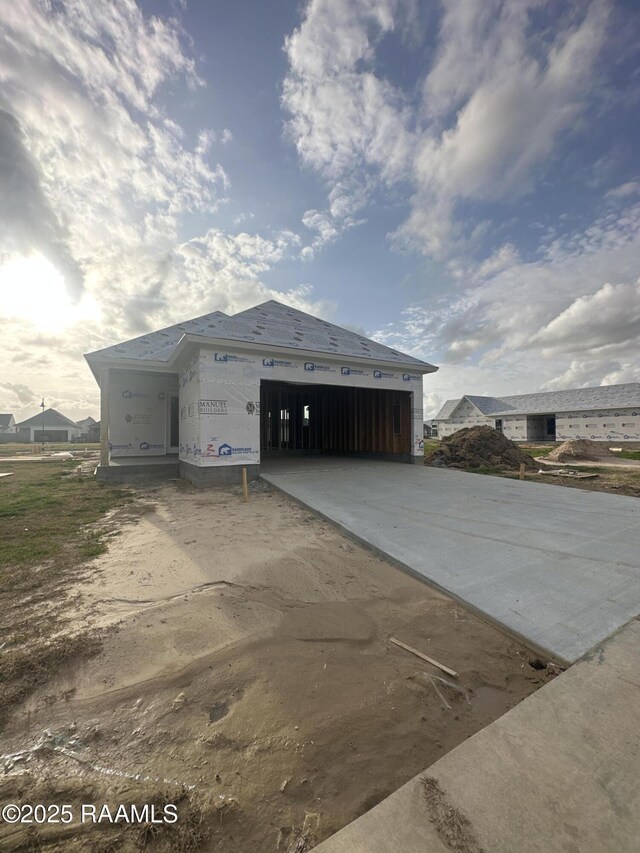 view of outbuilding with driveway and an attached garage