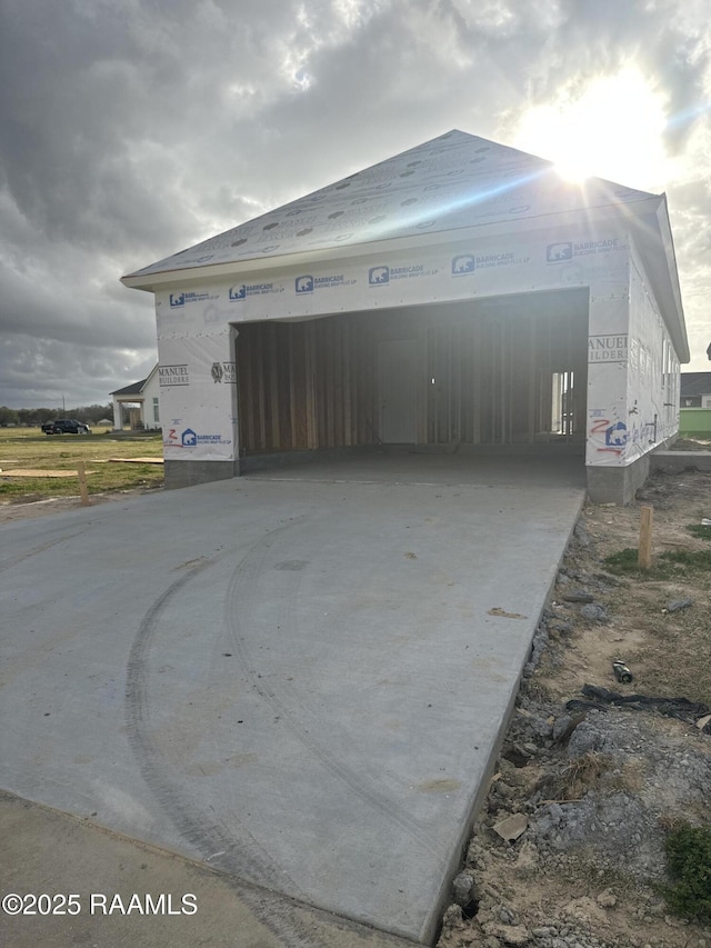 garage featuring concrete driveway