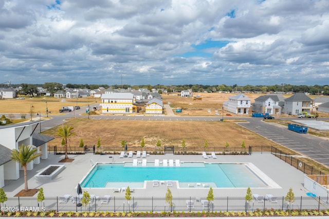 pool featuring a residential view, fence, and a patio