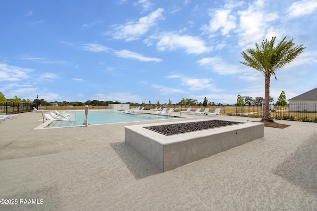 community pool featuring fence and a patio area