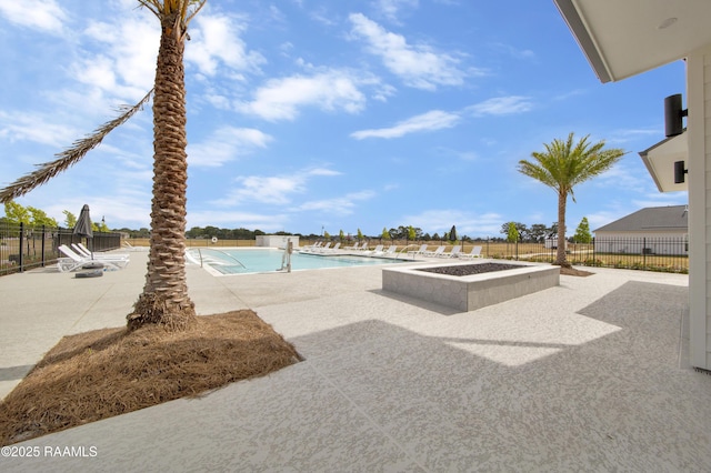 community pool with fence and a patio
