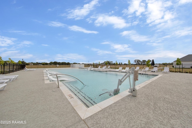 pool featuring a patio and fence